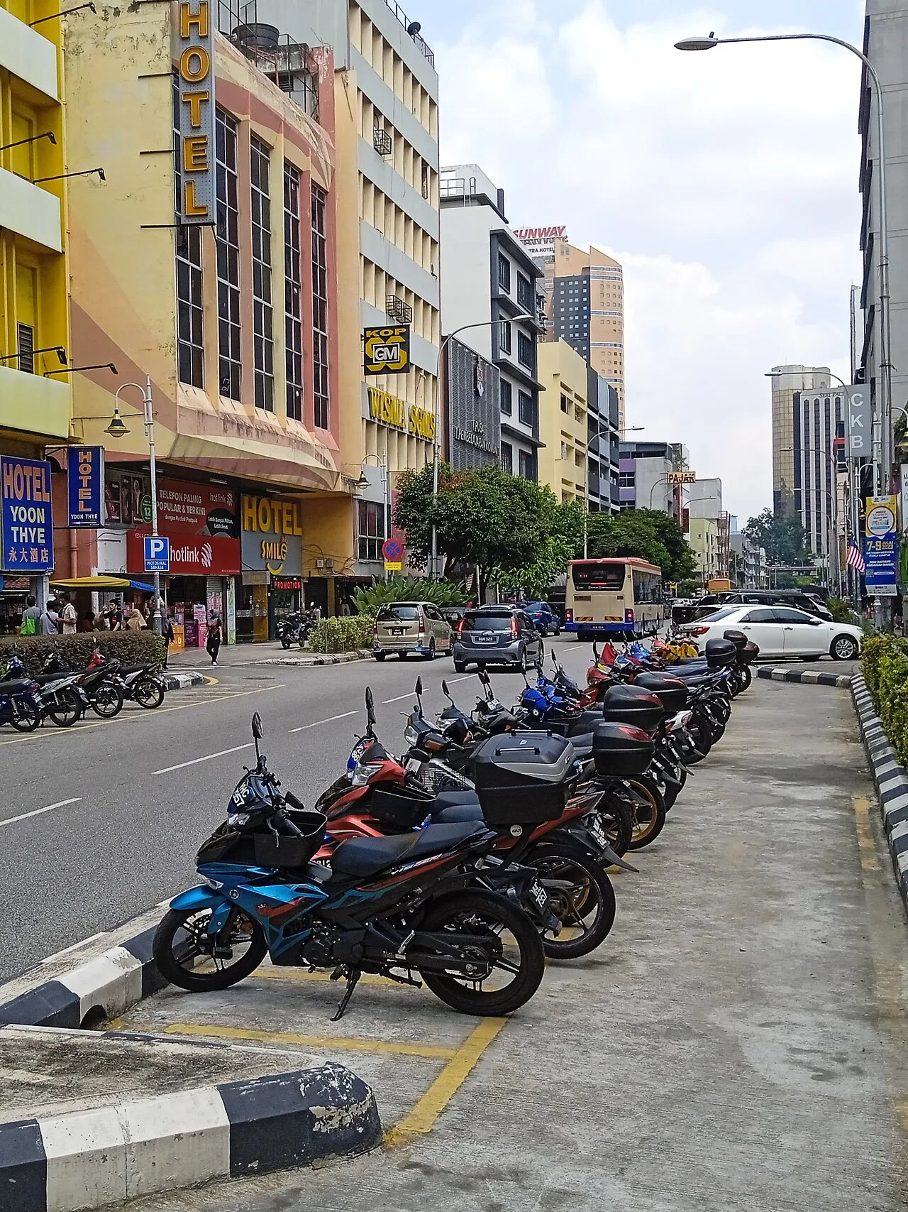 Hotels, shops and parked motorcycles along Jalan Chow Kit.