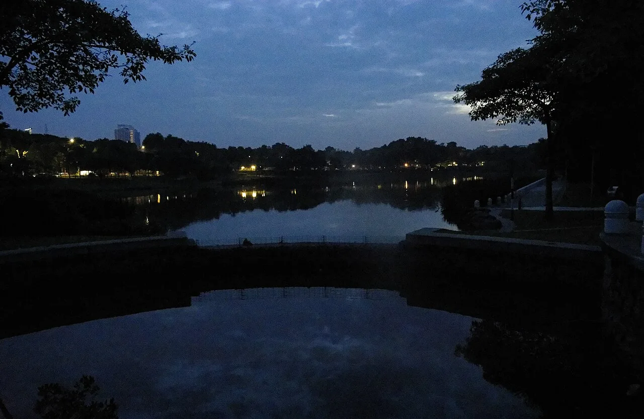 Desa ParkCity's central lake at dusk.