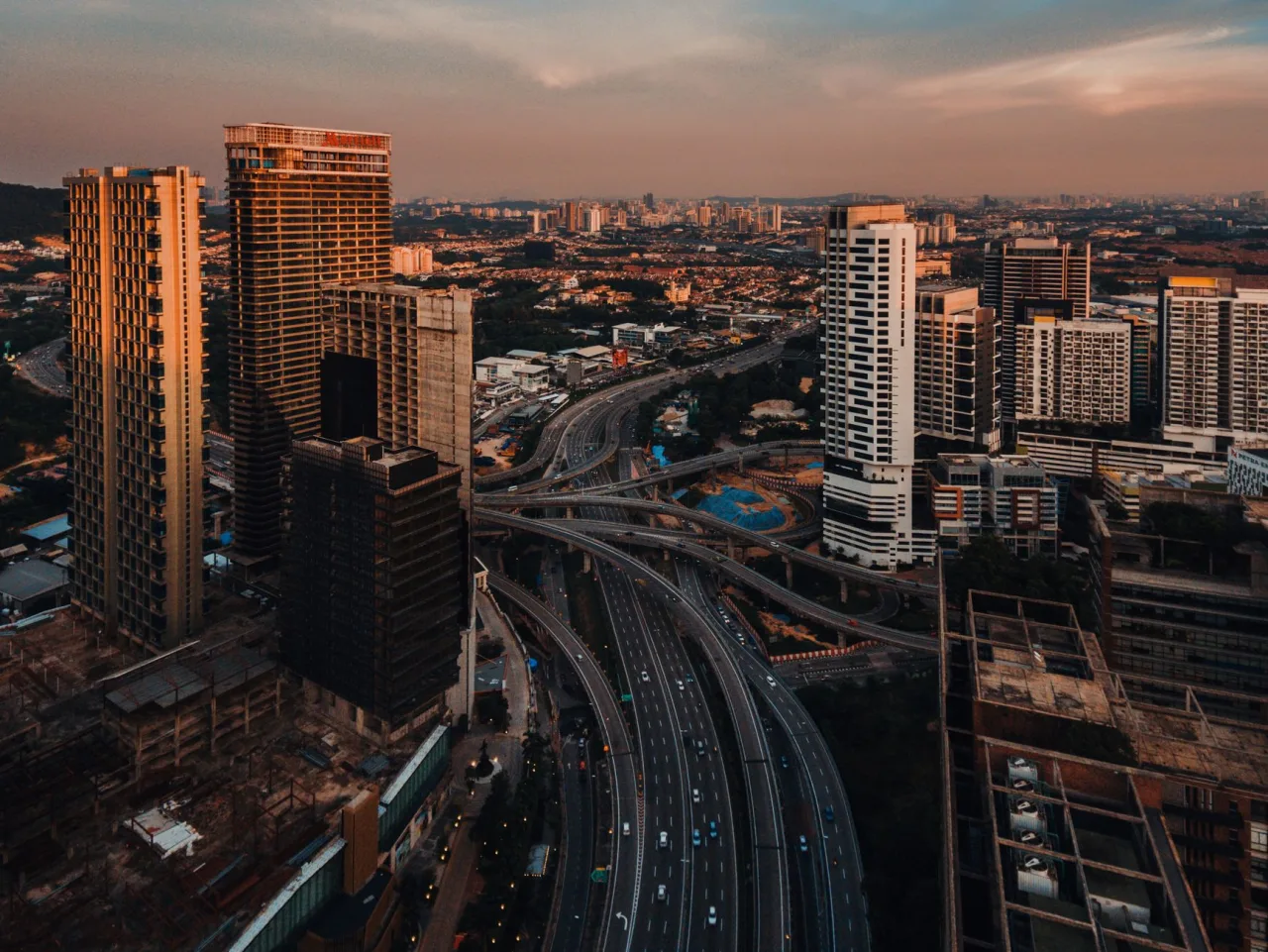 Petaling Jaya cityscape and highway interchange at dusk.