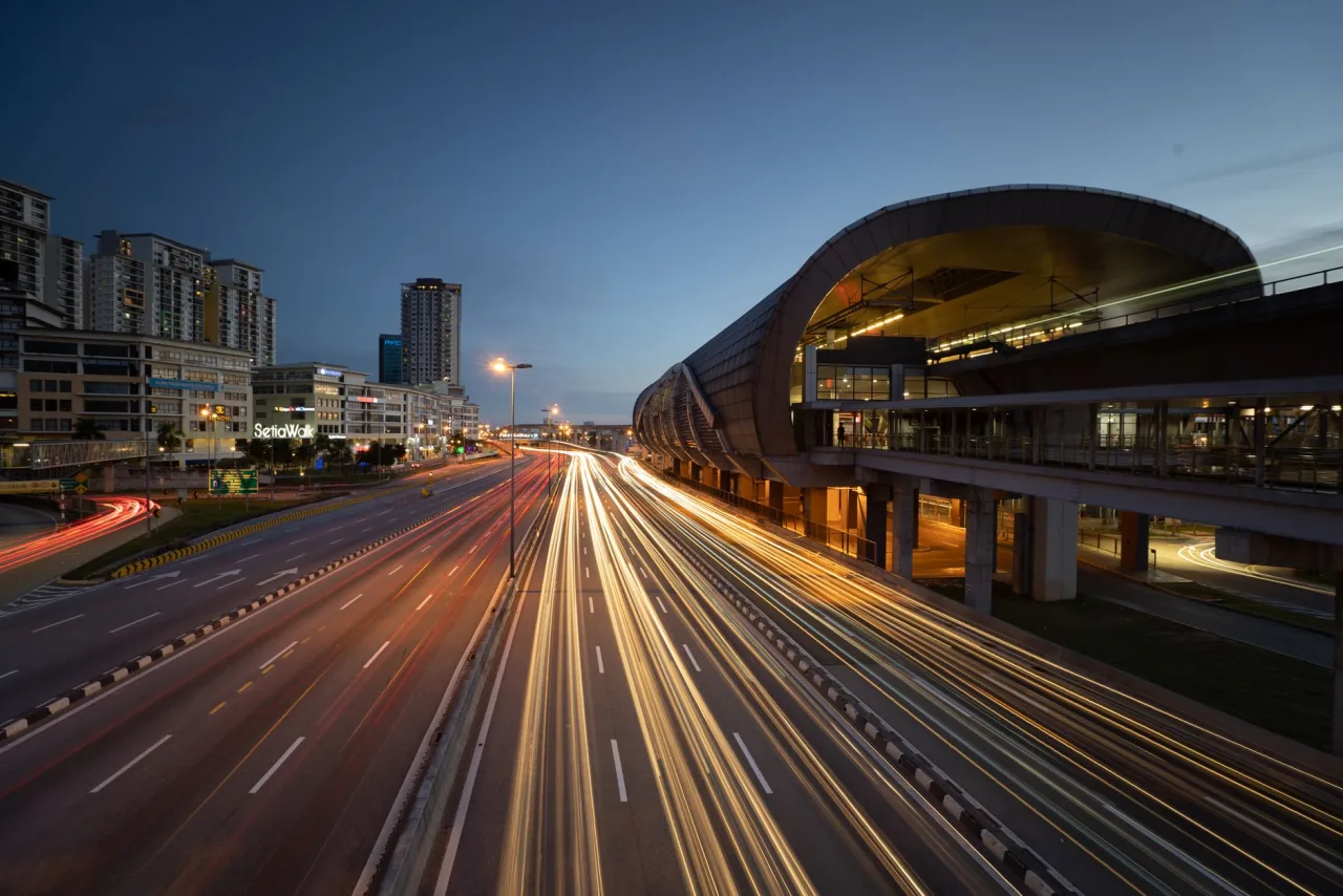 Puchong streets, elevated rail and the SetiaWalk district at blue hour.