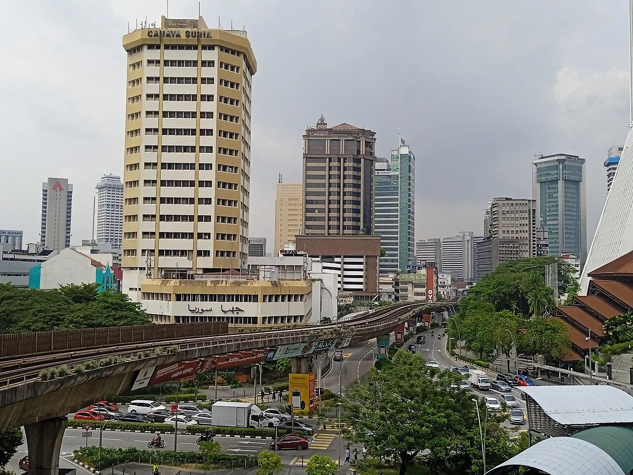 Aerial view over Pudu's dense low-rise streets and city towers.