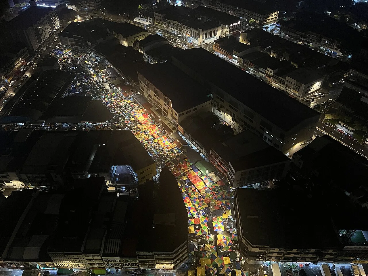 The brightly covered lanes of Pudu wet market at night.