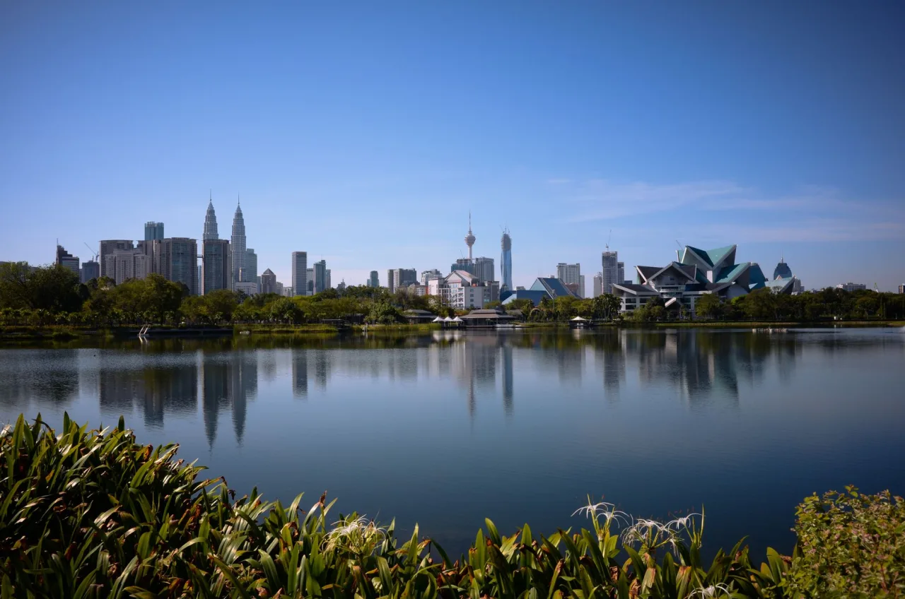 Titiwangsa Lake with Istana Budaya and the Kuala Lumpur skyline beyond it.